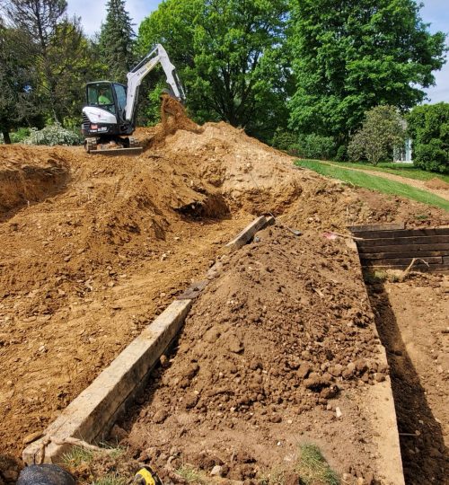 Contractor located in York, PA operating an excavator for building retaining wall