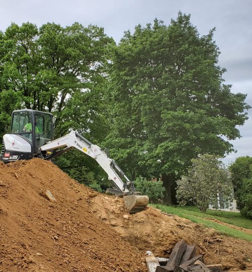 York, PA Excavating Contractor operates excavator for outdoor pool project